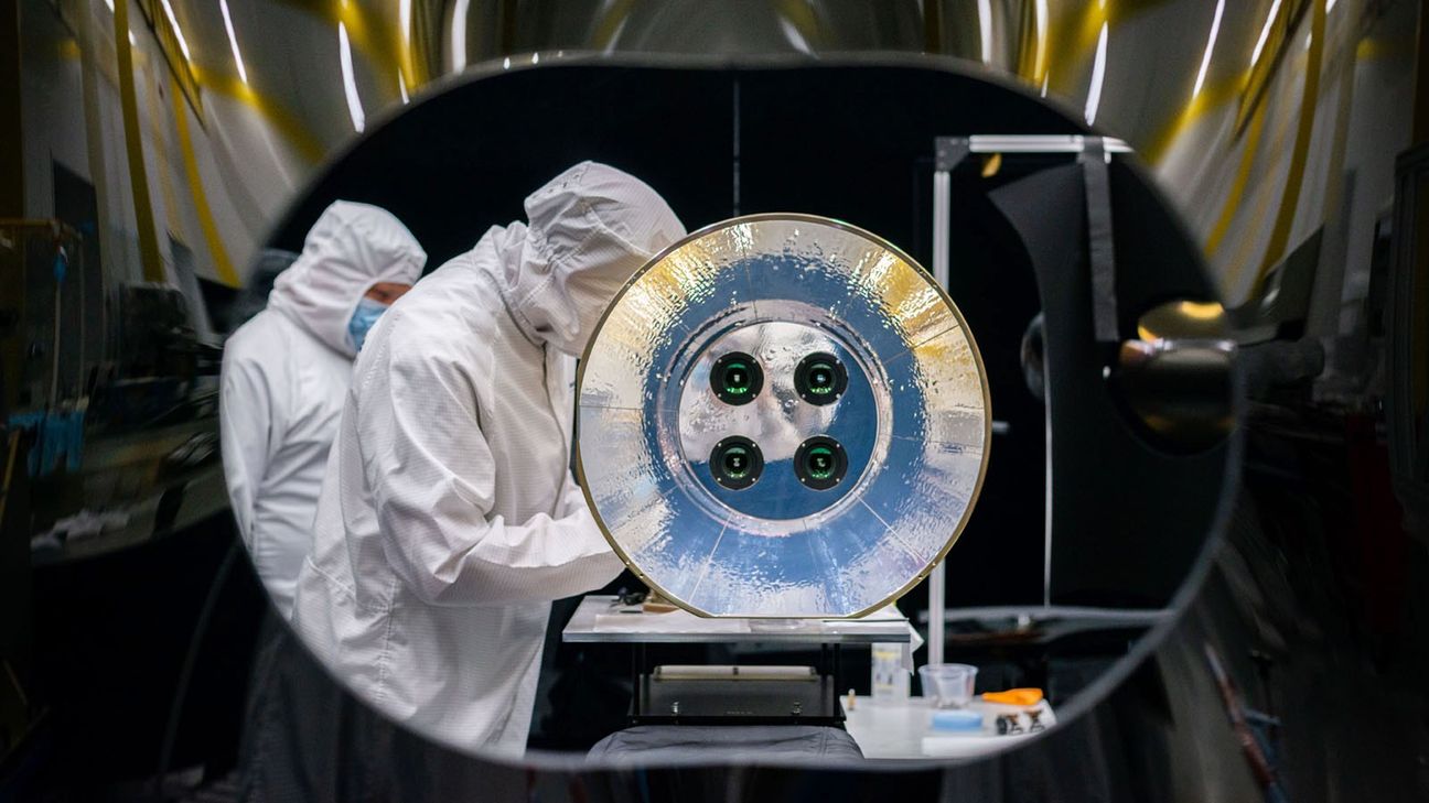 SDL engineers work on the AWE telescope in a cleanroom at SDL facilities on USU's Innovation Campus in North Logan. AWE's four telescopes and aperture baffle are shown in this image.