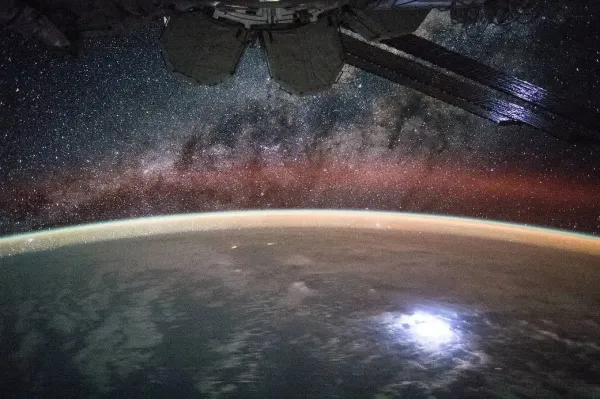 This image taken from the International Space Station shows swaths of airglow hovering in Earth’s atmosphere. NASA’s new Atmospheric Waves Experiment will observe airglow from a perch on the space station to help scientists understand, and ultimately improve forecasts of, space weather changes in the upper atmosphere. NASA