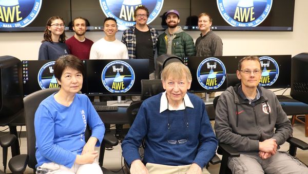 USU's AWE Science Team members, front from left, Physics researchers Yucheng Zhao, Professor Mike Taylor, principal investigator; and Pierre-Dominique Pautet; second row, USU students Anastasia Brown-King, Dallin Tucker, Anh Phan, Eric David and Joseph Pigott, and USU alum Jacob Adams, in the operations room where they await data from the AWE mission instrument scheduled to travel on the International Space Station. (Photo: USU/M. Muffoletto)