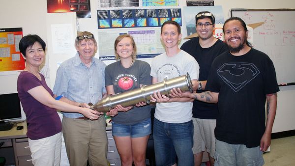 Physics professor Mike Taylor, second from left, celebrates with colleagues and students in August 2017, after learning his team, along with Space Dynamics Laboratory, was awarded NASA funding to pursue the AWE mission. Taylor, who passed away July 24, 2025, was a pioneer in atmospheric physics research and a much-admired faculty mentor. (Photo Credit: USU/M. Muffoletto)